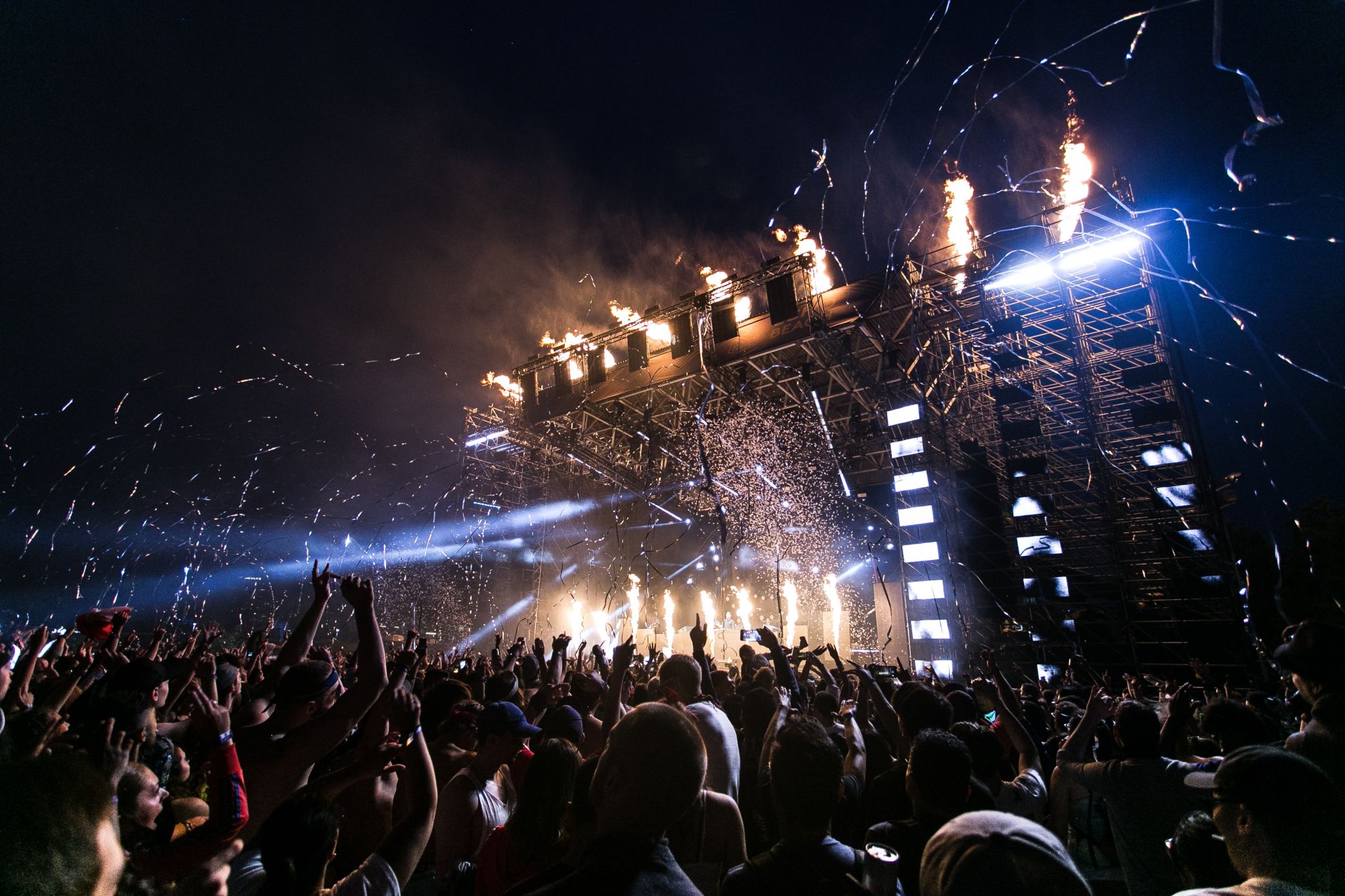 Crowd at festival with confetti and fireworks