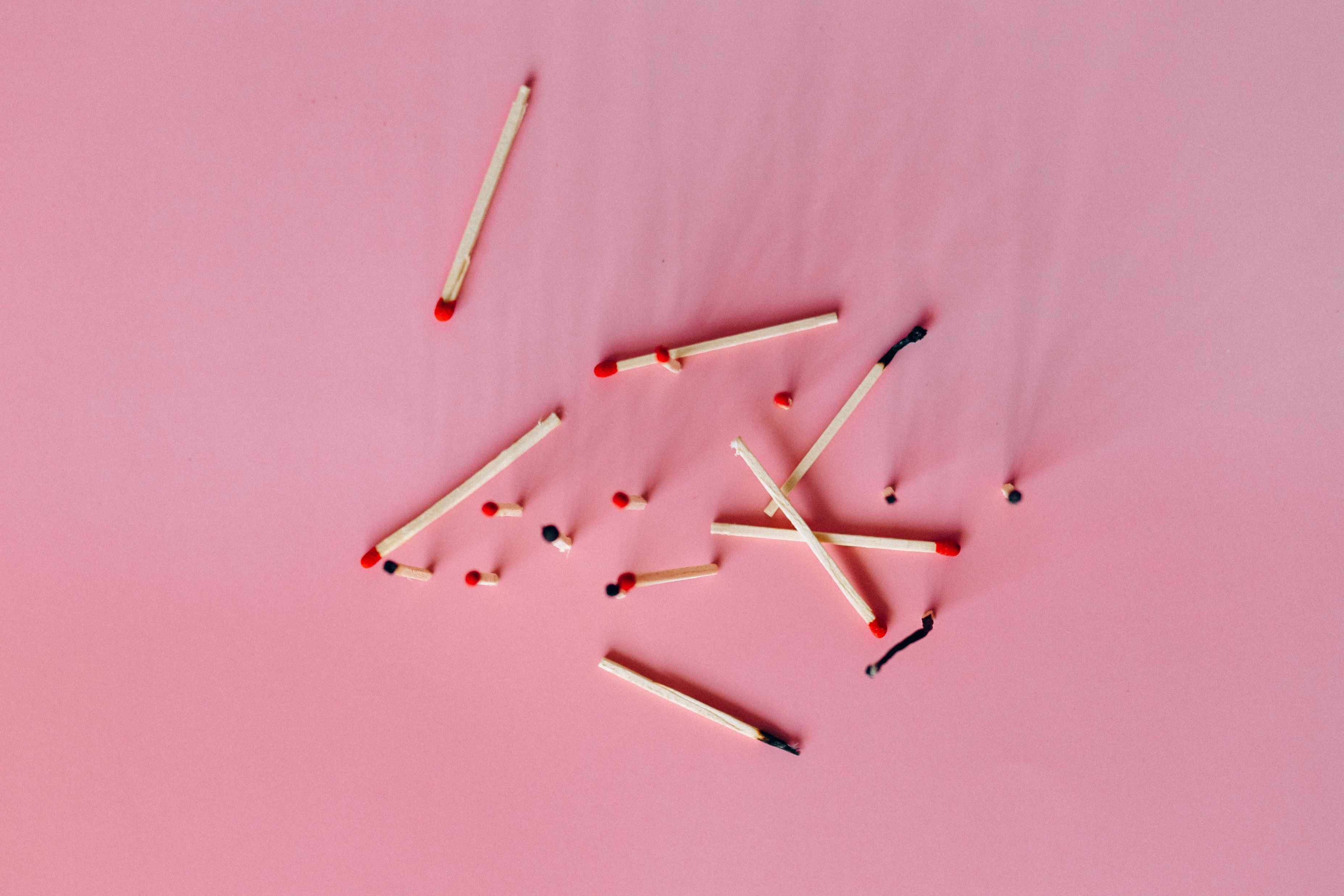 Burnt matches on a pink surface
