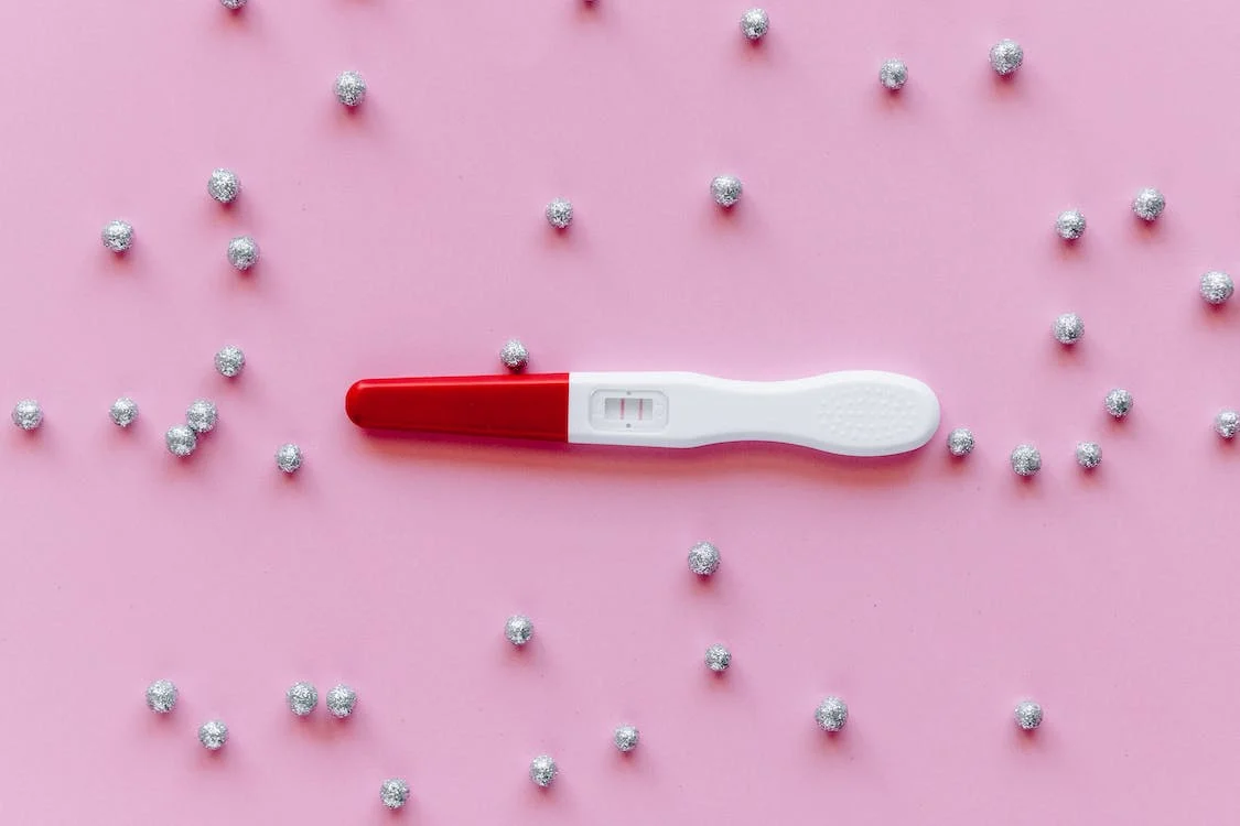 Pregnancy test on pink background