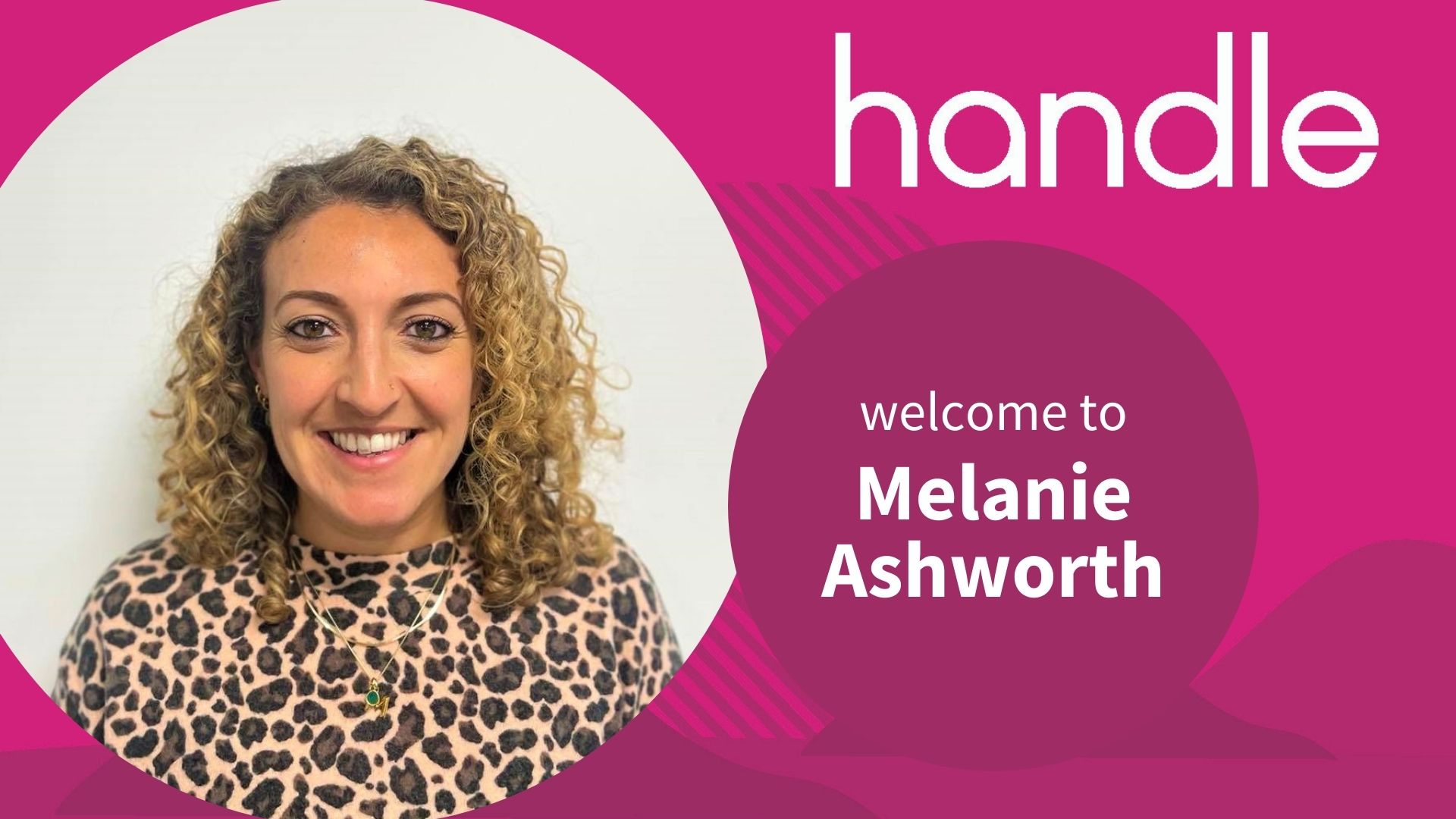 woman with curly hair smiling in frame with pink background