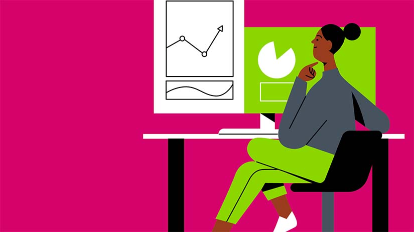 Woman sitting at desk looking at data