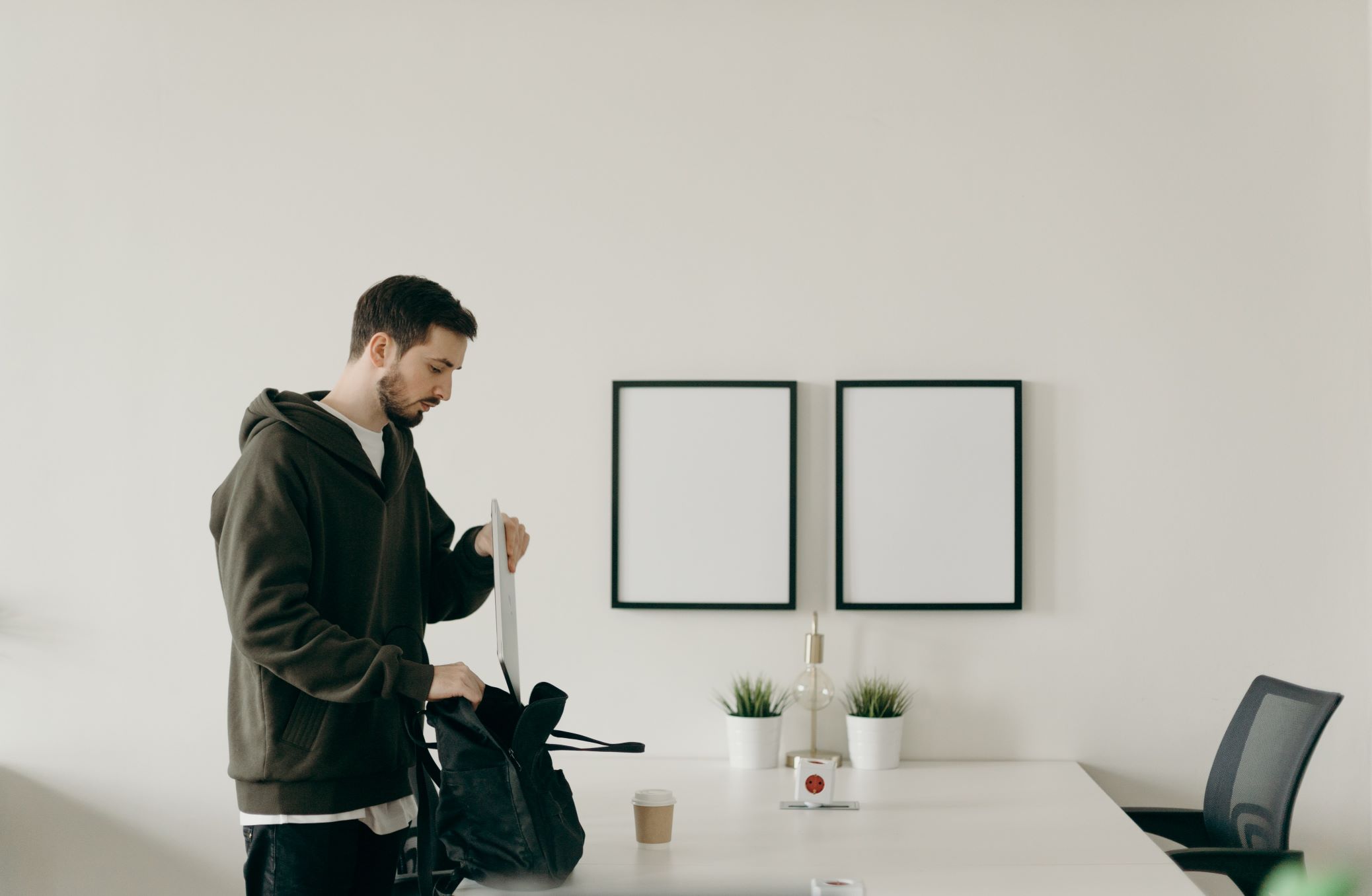 Man packing bag to leave office