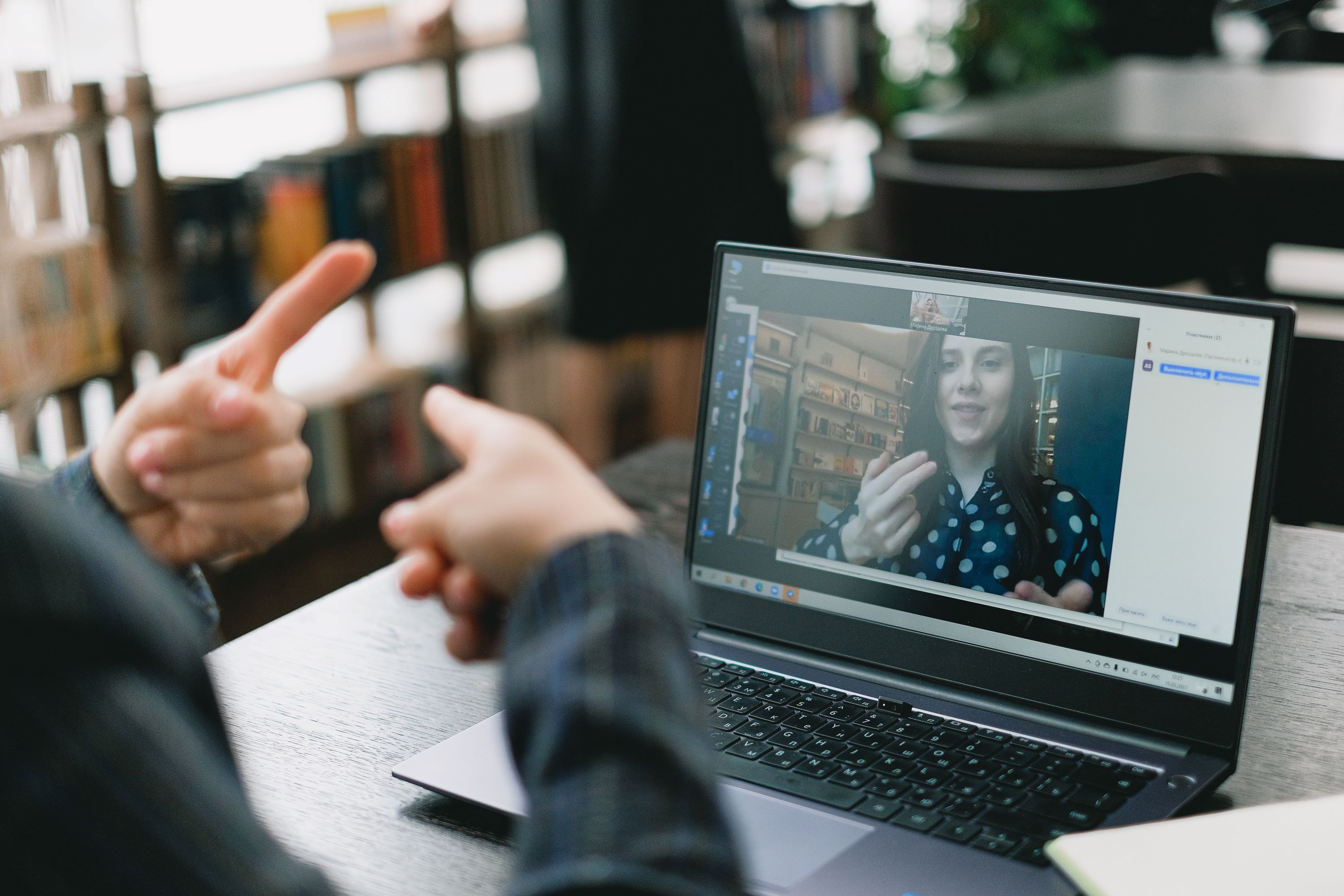 Person teaching sign language over video call