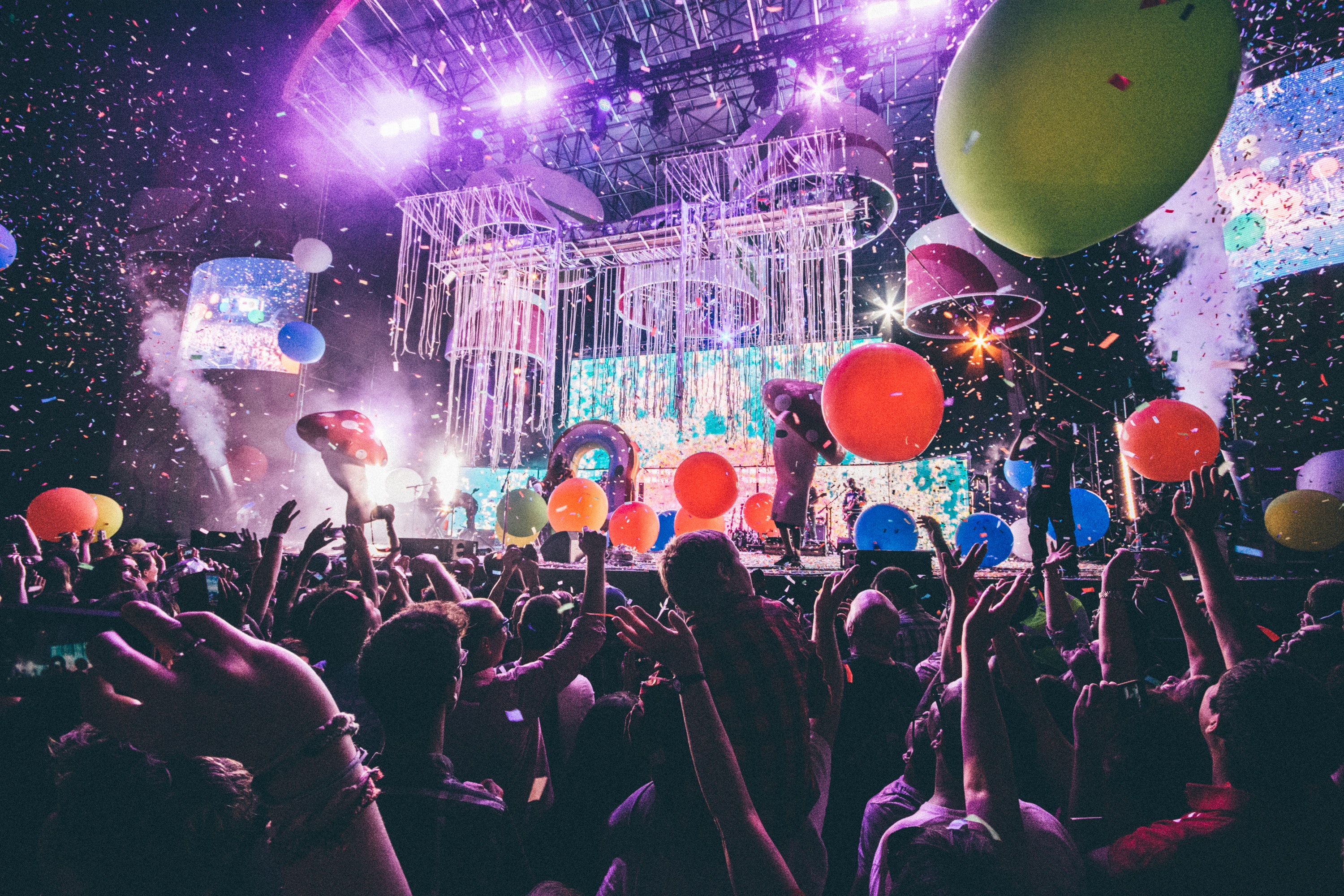 crowd of people at concert with coloured ballons